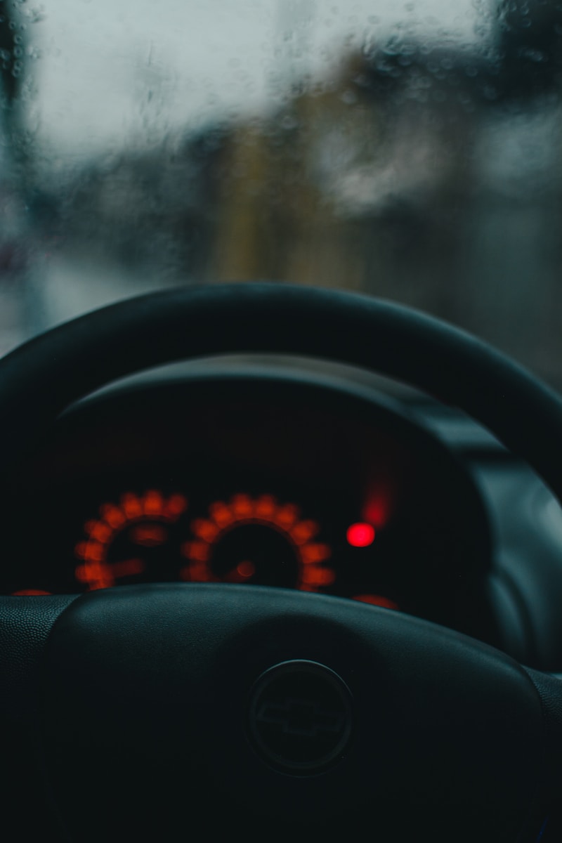 the dashboard of a car with a red light on
