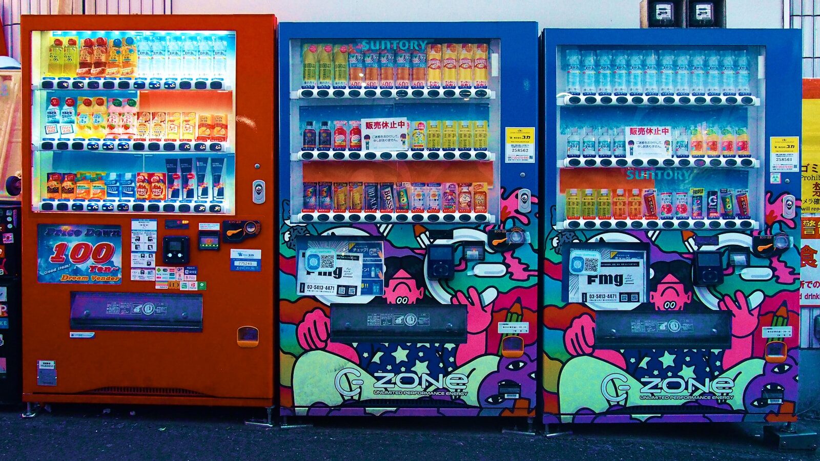 Three colorful vending machines with drinks and snacks